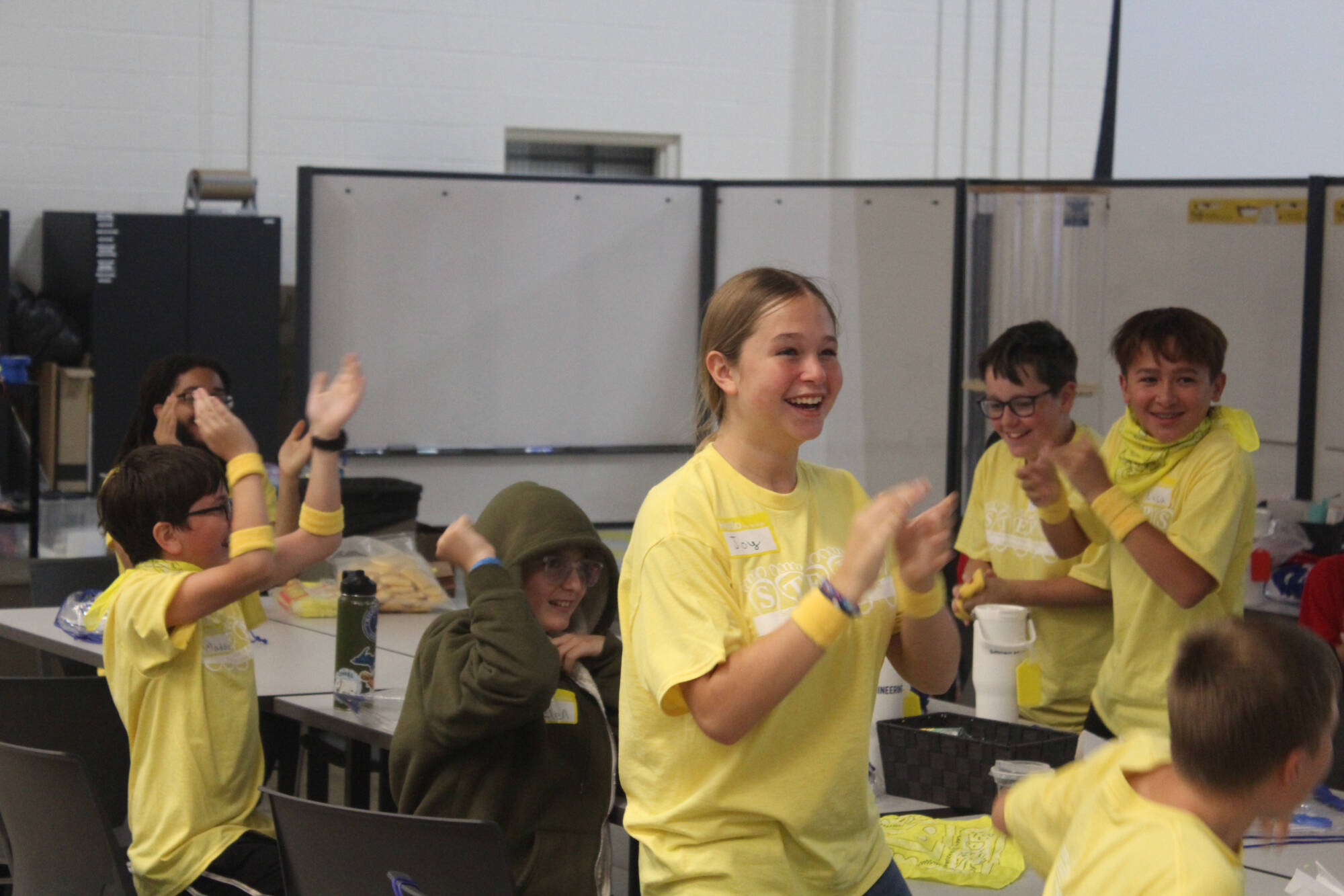 A group of STEPS campers applaud after being honored for their work